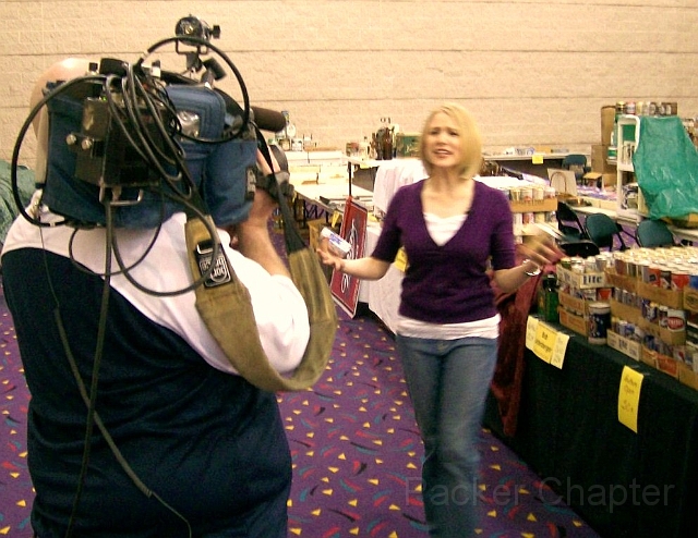 13.JPG - Alison appears overwhelmed by all the cans and breweriana.