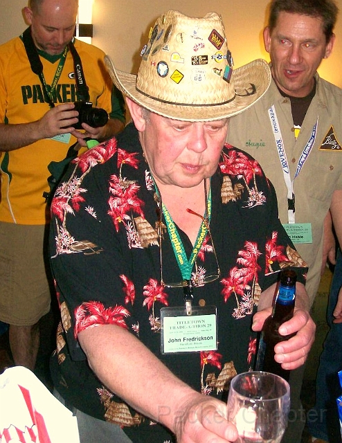 27.JPG - John Fredrickson demonstrates the self-serve bar in the Wisconsin Hospitality Room.
